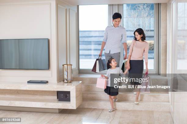 young family coming back from shopping - tv shop window stock pictures, royalty-free photos & images