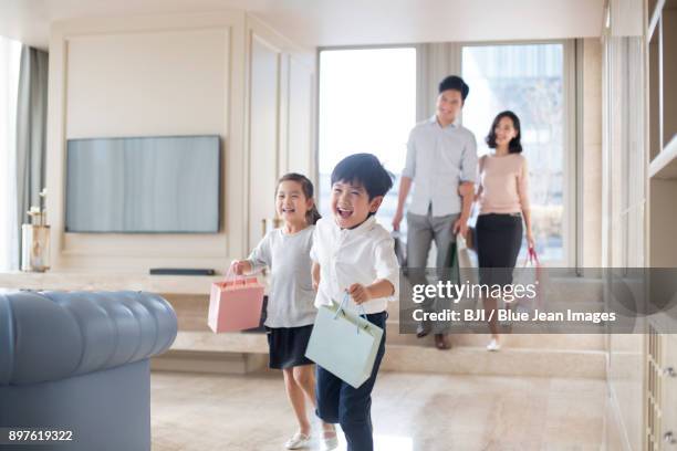 young family coming back from shopping - tv shop window stock pictures, royalty-free photos & images
