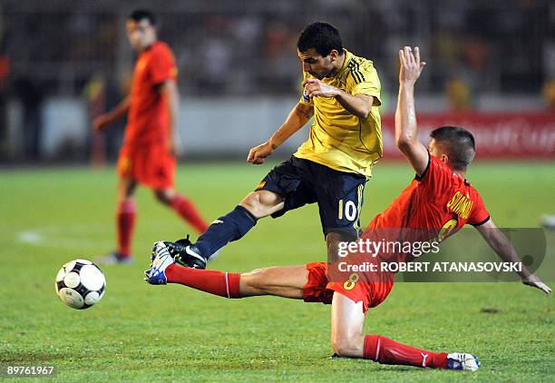 Spain's Cesc Fabregas runs for the ball with Macedonia's Velice Sumulikovski during an international friendly World Cup 2010 match between Macedonia...