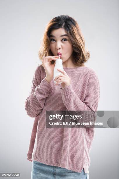 beautiful young woman drinking milk - yoghurt pot stock pictures, royalty-free photos & images