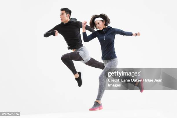 young couple jumping - china athlete woman stock pictures, royalty-free photos & images