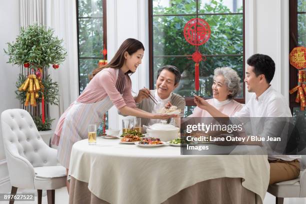 happy family having chinese new year dinner - trying new food stock pictures, royalty-free photos & images