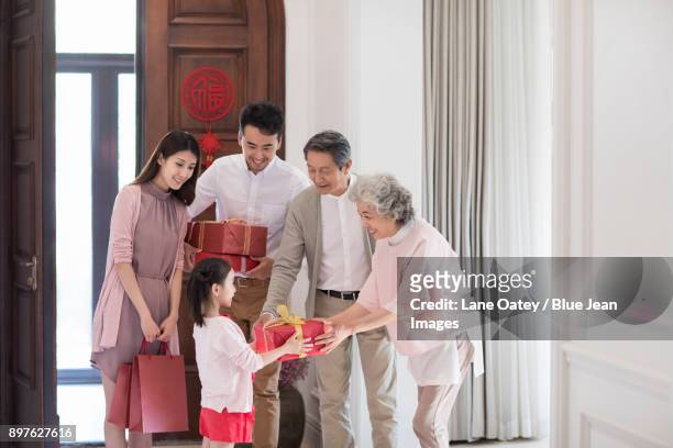 family visiting with gifts during chinese new year - blue house red door stock pictures, royalty-free photos & images