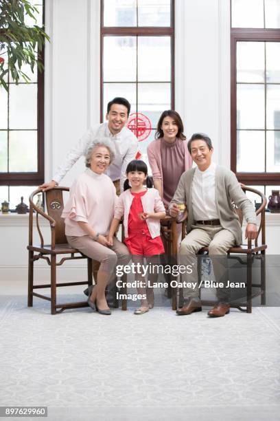 happy family celebrating chinese new year - 30 year old portrait in house stockfoto's en -beelden