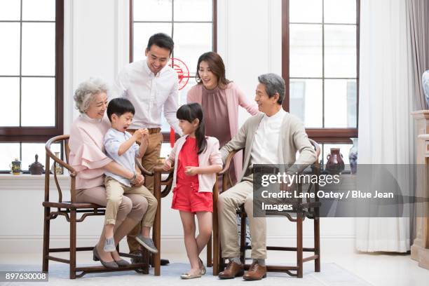 happy family celebrating chinese new year - mom blessing son stockfoto's en -beelden