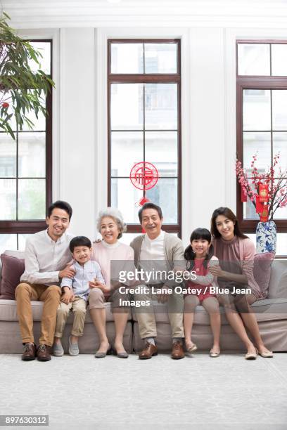 happy family celebrating chinese new year - 30 year old portrait in house stock-fotos und bilder