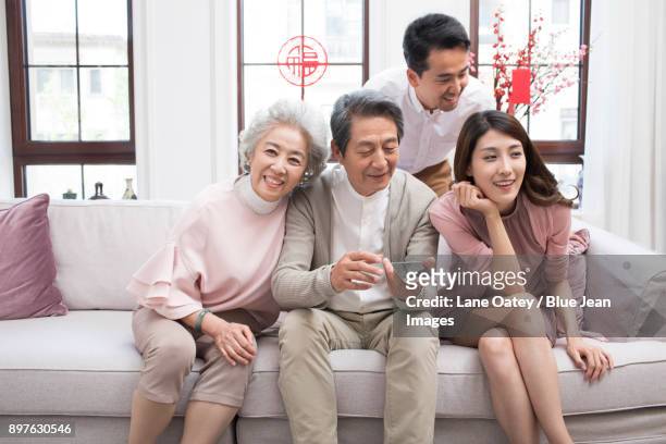 happy family talking on the phone during chinese new year - 30 year old woman stockfoto's en -beelden