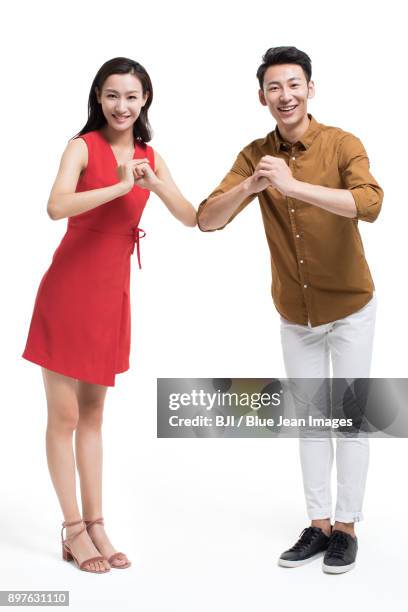 cheerful young couple greeting for chinese new year - bainian stock pictures, royalty-free photos & images