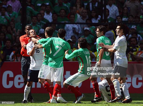 Benny Feilhaber of the USA comes to the aide of teammate Charlie Davies of the USA and is choked by Gerardo Torrado of Mexico during the FIFA World...