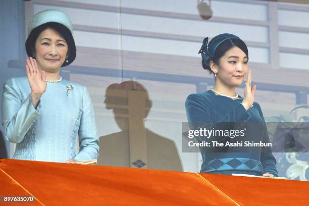 Princess Kiko and Princess Mako of Akishino wave to well-wishers during a session celebrating Emperor Akihito's 84th birthday at the Imperial Palace...