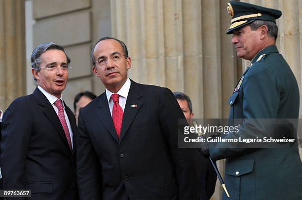 Colombia's President Alvaro Uribe and Army Forces chief Freddy Padilla meet Mexican President Felipe Calderon at the presidential residence Casa de...