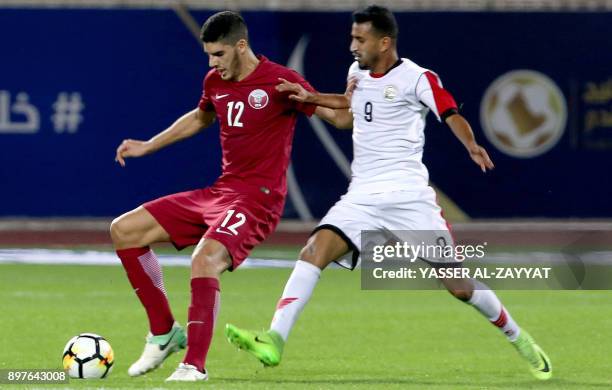 Yemen's midfielder Ala Al-Sasi vies for the ball against Qatar's midfielder Karim Boudiaf during their 2017 Gulf Cup of Nations football match...