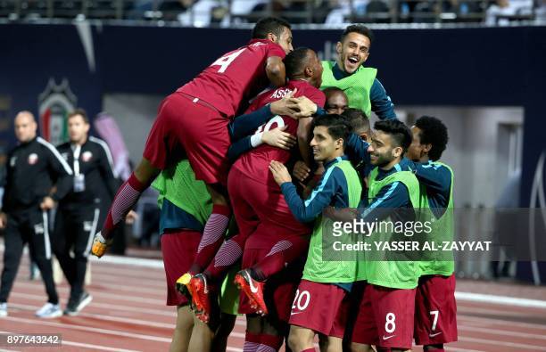 Members of Qatar's national football team celebrate after scoring a goal against Yemen during their 2017 Gulf Cup of Nations football match at the...