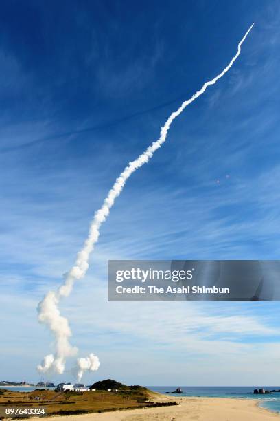 The HII-A No.37 rocket leaves the contrail after its launch at the Japan Aerospace Exploration Agency Tanegashima Space Center on December 23, 2017...