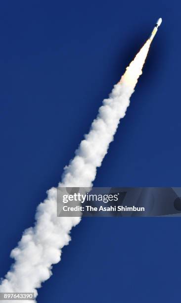 The HII-A No.37 rocket leaves the contrail after its launch at the Japan Aerospace Exploration Agency Tanegashima Space Center on December 23, 2017...