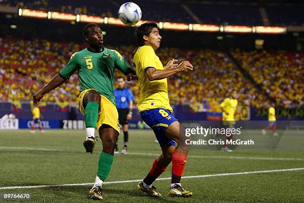Devon Hodges of Jamaica contests the ball with Christian Noboa of Ecuador during their match at Giants Stadium on August 12, 2009 in East Rutherford,...