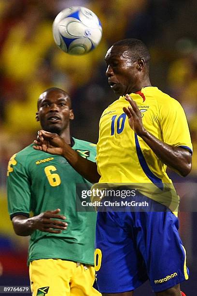 Walter Ayovi of Ecuador heads the ball away from Omar Cummings of Jamaica during their match at Giants Stadium on August 12, 2009 in East Rutherford,...