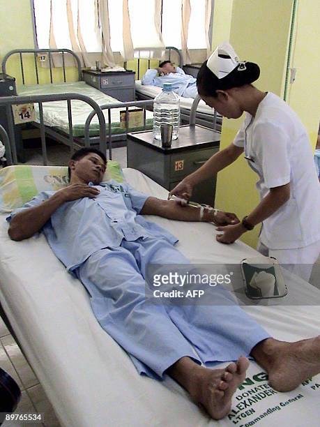 Wounded Philippine Marine receives treatment at a hospital in the southern Philippine city of Zamboanga on August 13, 2009 a day after soldiers and...