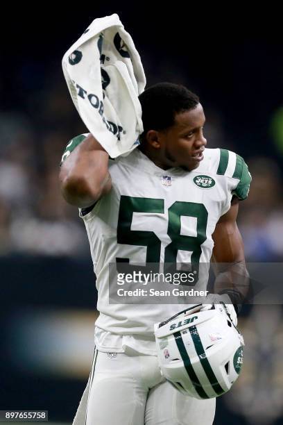 Darron Lee of the New York Jets wipes sweat from his brow during a NFL game against the New Orleans Saints at the Mercedes-Benz Superdome on December...