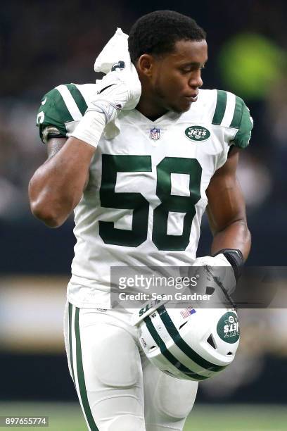 Darron Lee of the New York Jets wipes sweat from his brow during a NFL game against the New Orleans Saints at the Mercedes-Benz Superdome on December...