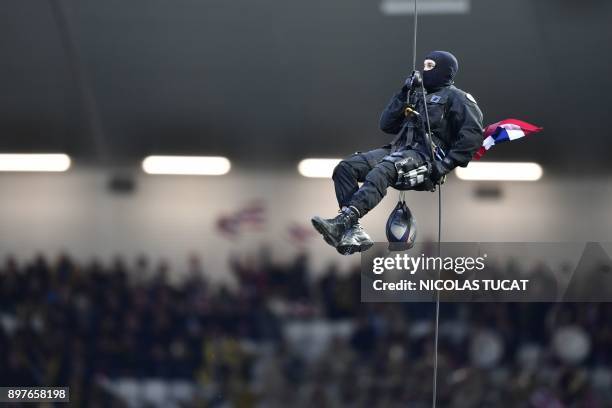 Member of police special force repels onto the pitch with a rugby ball prior to the French Top 14 rugby union match between Bordeaux-Begles and La...
