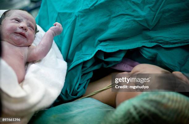 newborn child seconds and minutes after birth. - labor childbirth stock pictures, royalty-free photos & images