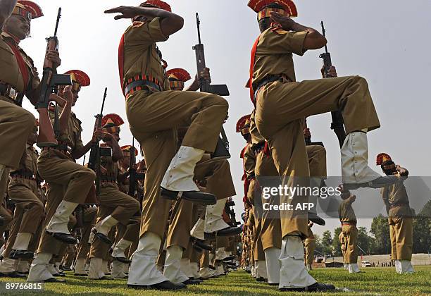 Indian Border Security Force soldiers participate in a rehearsal for an Independence Day parade at Bakshi stadium in Srinagar on August 13, 2009....