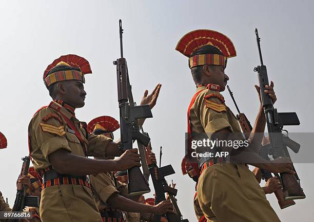 Indian Border Security Force soldiers participate in a rehearsal for an Independence Day parade at Bakshi stadium in Srinagar on August 13, 2009....