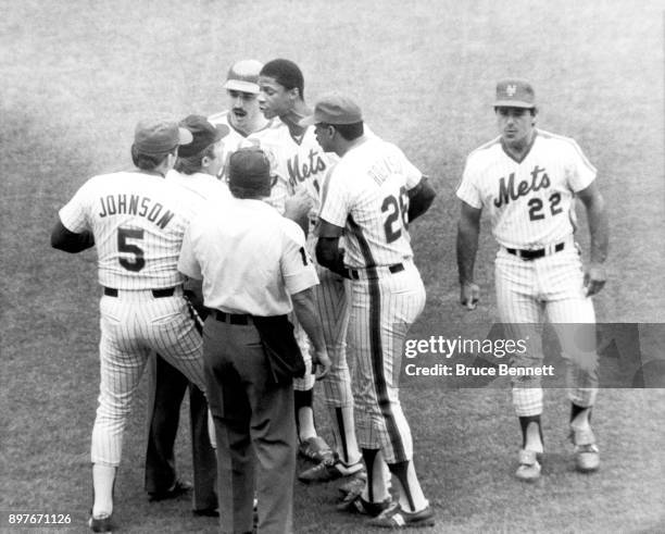 Keith Hernandez and Darryl Strawberry of the New York Mets argue with the umpire as manager Davey Johnson, Bill Robinson and Bobby Valentine listen...