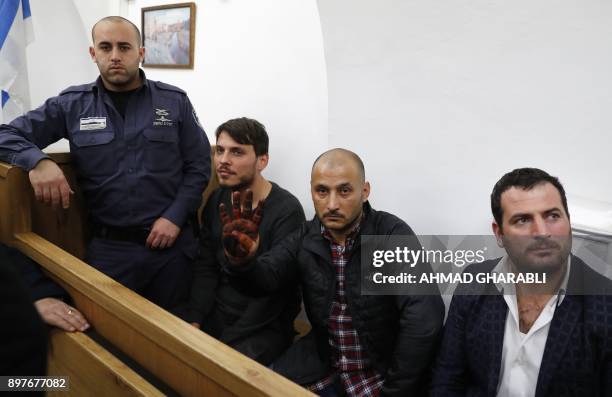 Turkish tourists, who were arrested earlier in the week at a holy site in Jerusalem following Muslim prayers, are seen at an Israeli court in...