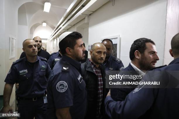 Turkish tourists , who were arrested earlier in the week at a holy site in Jerusalem following Muslim prayers, are seen at an Israeli court in...