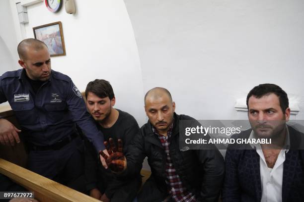 Turkish tourists, who were arrested earlier in the week at a holy site in Jerusalem following Muslim prayers, are seen at an Israeli court in...