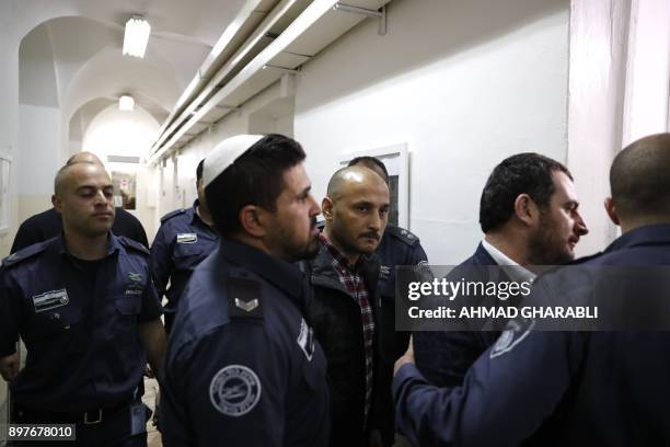 Turkish tourists, who were arrested earlier in the week at a holy site in Jerusalem following Muslim prayers, are seen entering an Israeli court in...