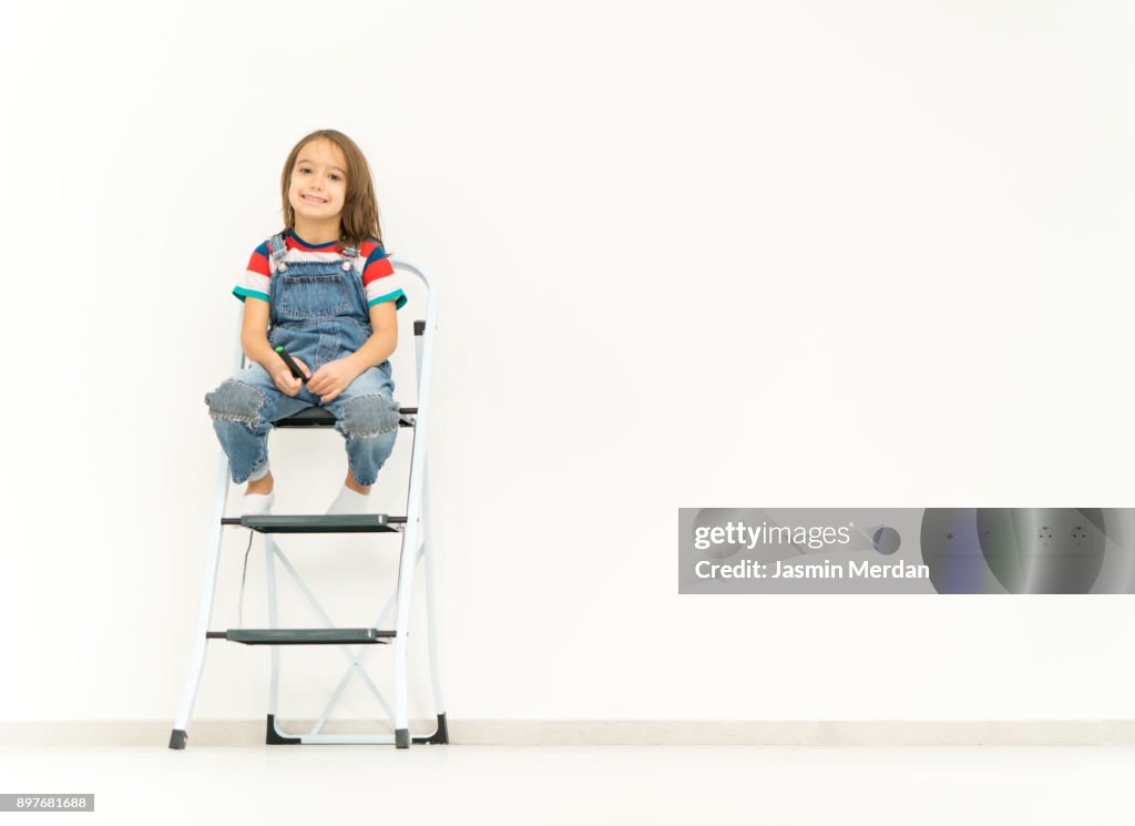 Child on empty wall copy space