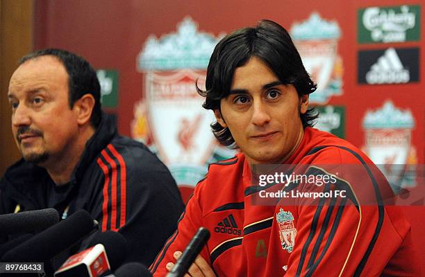 Liverpool's new signing Alberto Aquilani talks to the media whilst manager Rafael Benitez looks on at Melwood on August 13, 2009 in Liverpool,...
