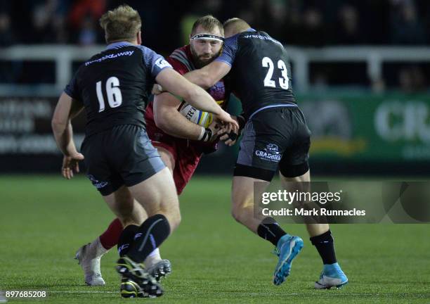 Joe Marler of Harlequins is tackled by Alex Tait and Ben Sowrey of Newcastle Falcons during the Aviva Premiership match between Newcastle Falcons and...