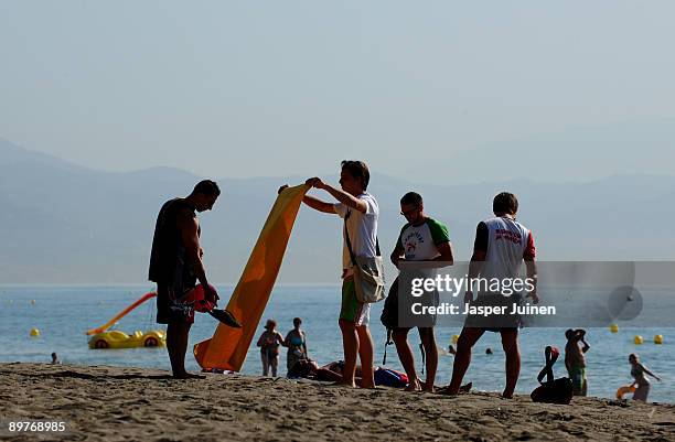 Tourists arrive at a usually packed Costa del Sol Carihuela beach on August 13, 2009 in Torremolinos, Spain. Altough Spanish resorts remain busy,...