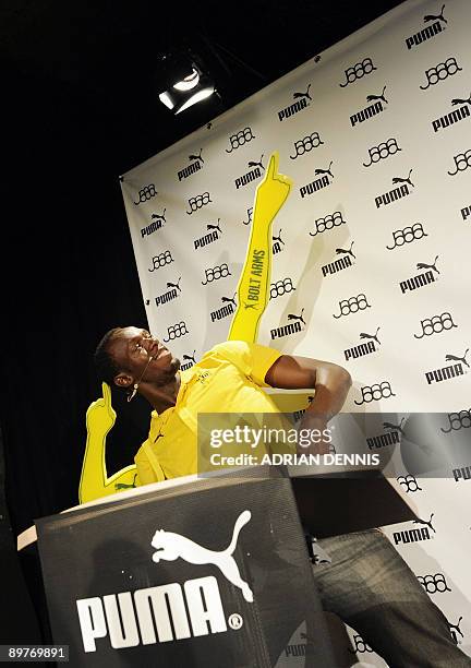 Double-Olympic sprint champion Usain Bolt of Jamaica poses with styrofoam arms during a press conference in Berlin August 13, 2009 were he was...