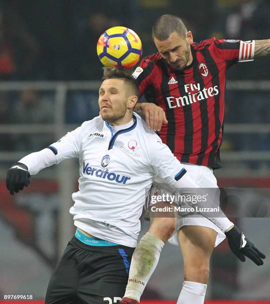 Jasmin Kurtic of Atalanta BC competes for the ball with Leonardo Bonucci of AC Milan during the serie A match between AC Milan and Atalanta BC at...