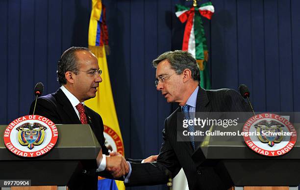 Colombia's President Alvaro Uribe greets Mexico's President Felipe Calderon during a joint press conference at the presidential residence Casa de...