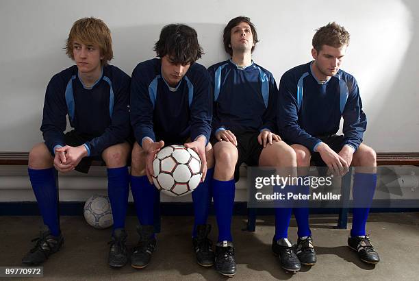 footballers in a changing room - football bench stock pictures, royalty-free photos & images