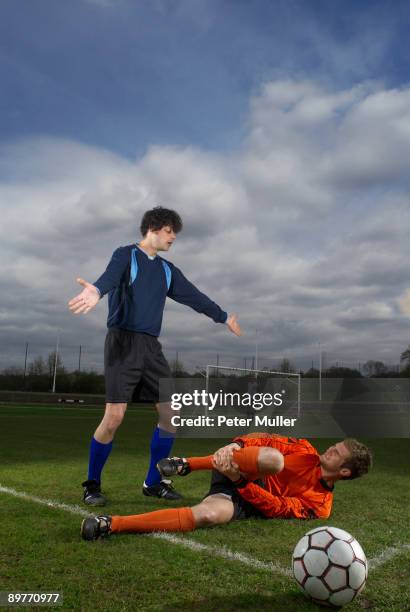 footballer fouled by another player - sad soccer player stock pictures, royalty-free photos & images