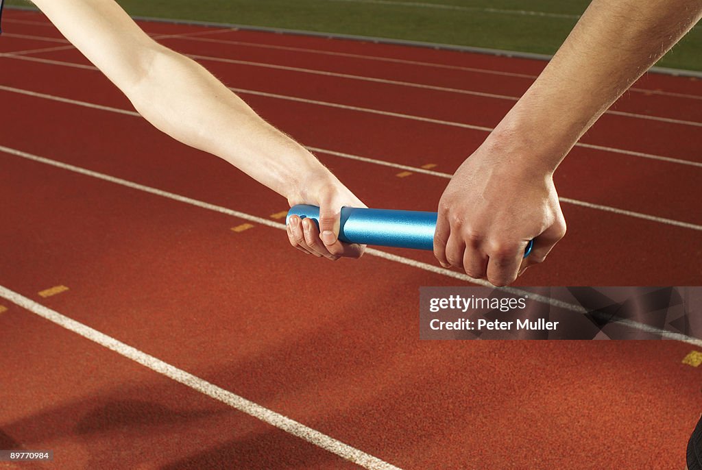 Relay baton being exchanged