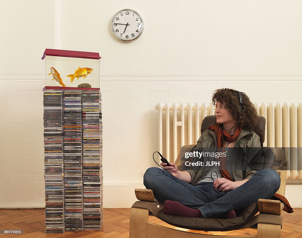 Young woman in chair listening to music