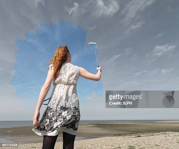young woman painting grey sky blue - hope concept woman stock pictures, royalty-free photos & images