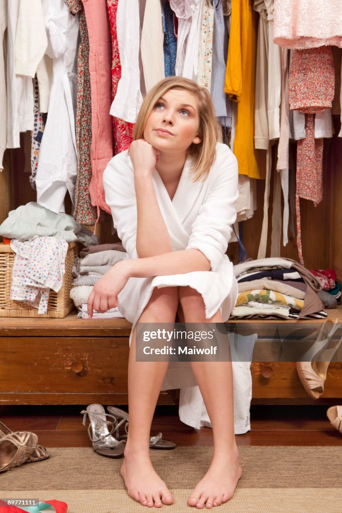 Woman sitting in her closet