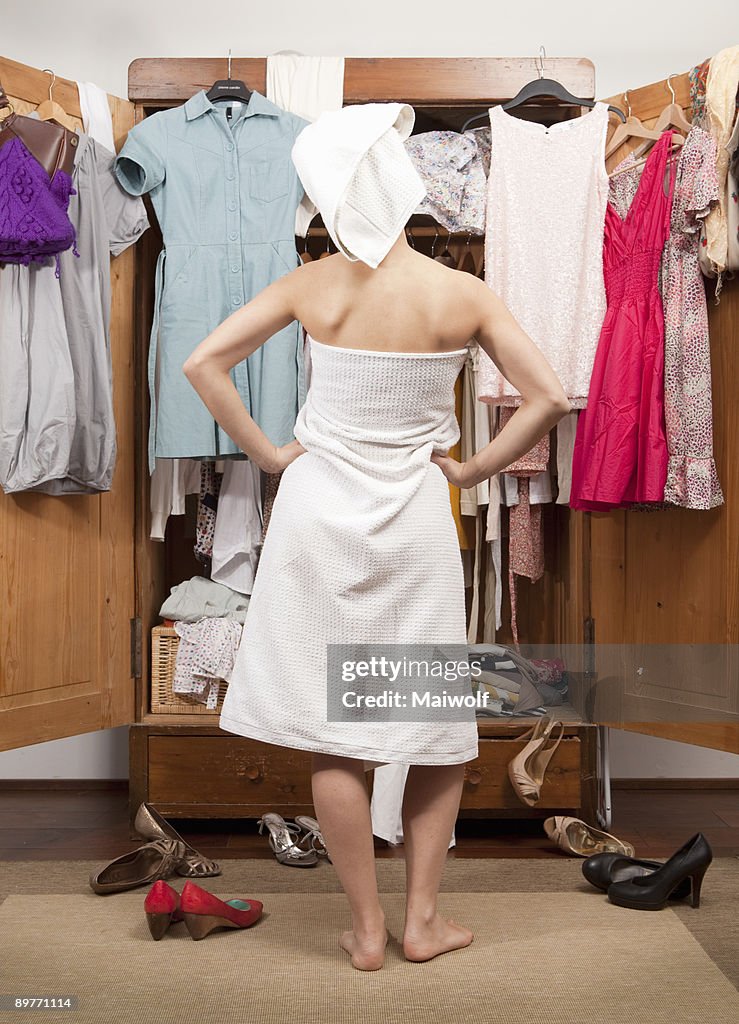 Woman in front of her closet, back view