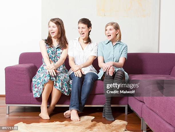 three women on a sofa, screaming. - three people on couch stock pictures, royalty-free photos & images