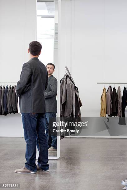 man looking at himself in mirror - full length mirror stock-fotos und bilder