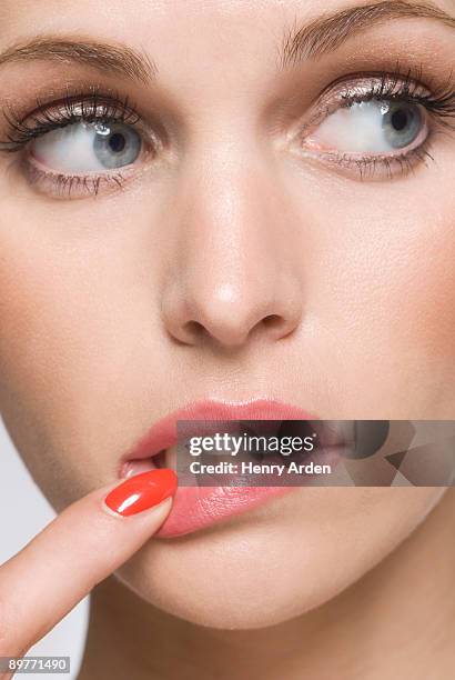 female beauty with finger in mouth - finger on lips stock-fotos und bilder